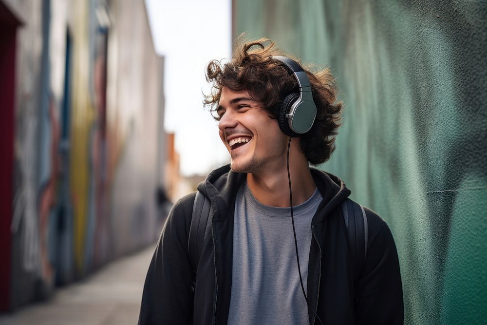 Young man enjoying music while walking in the wall streets headphones headset smile. AI generated Image by rawpixel.