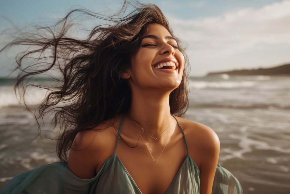 South Asian laughing beach smile. AI generated Image by rawpixel.