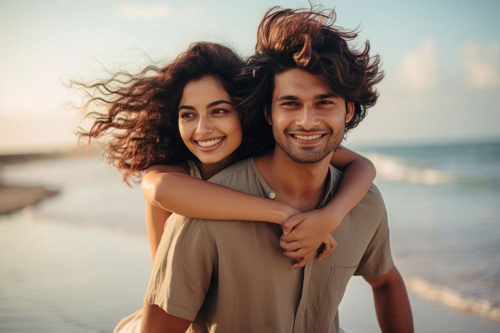 Young South Asian couple portrait smile beach. 