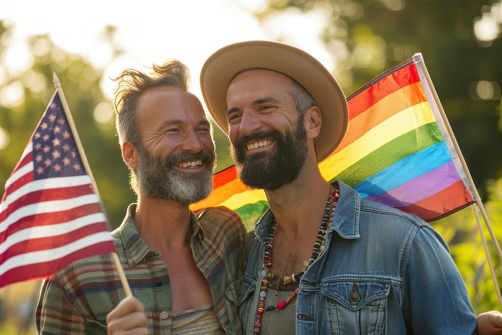 A joyful gay couple with America flags portrait parade adult.