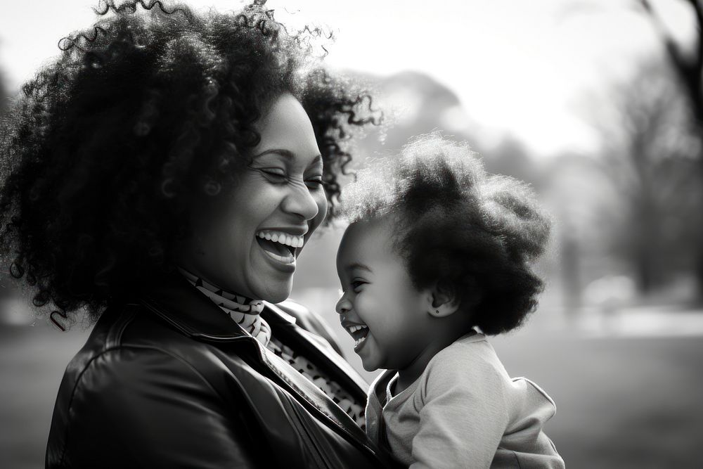 Black family laughing portrait outdoors.