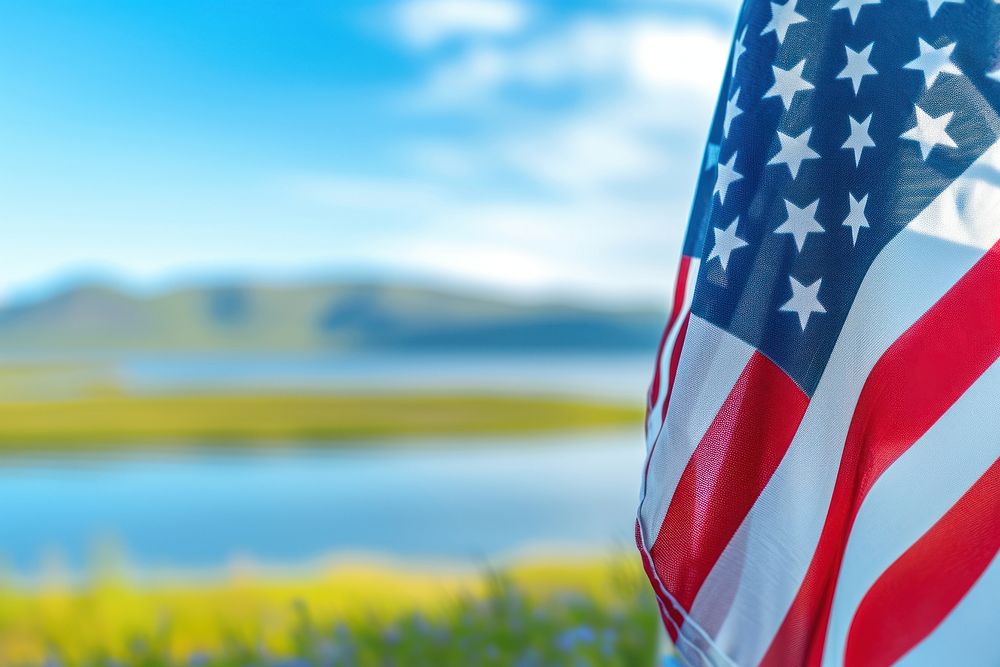 Close up of The America flag against Alaska landscape summer independence tranquility.