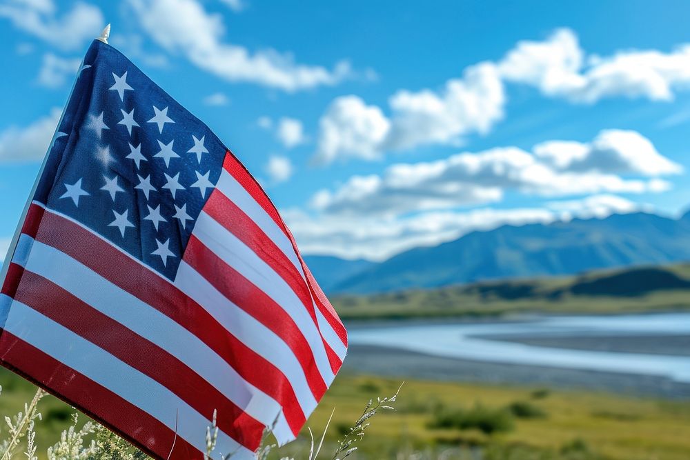 Close up of The America flag against Alaska landscape independence patriotism symbolism.