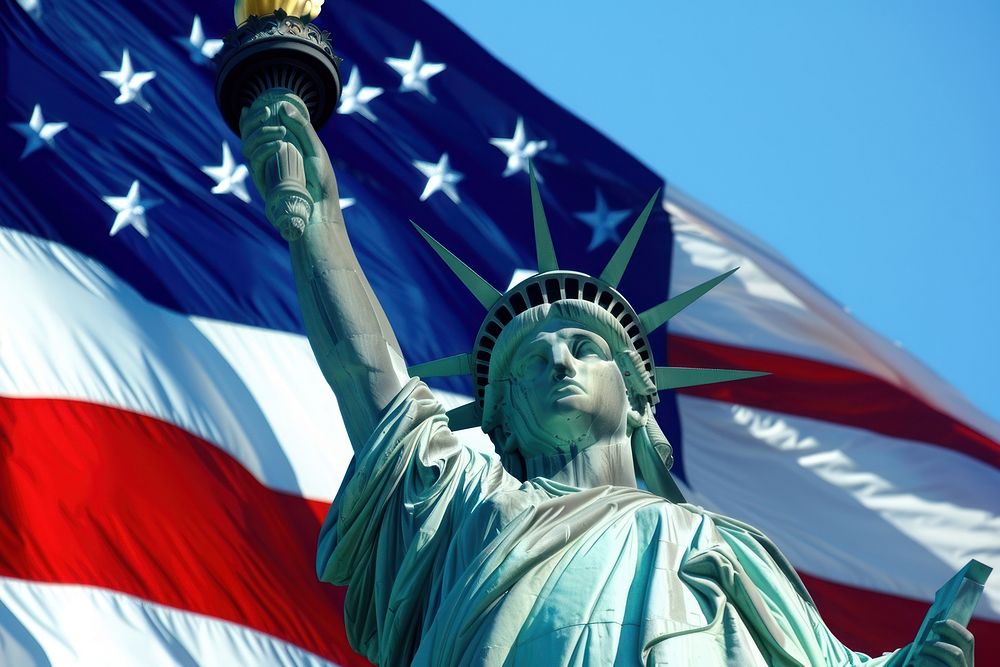 The Statue of Liberty against America flag statue sculpture representation.