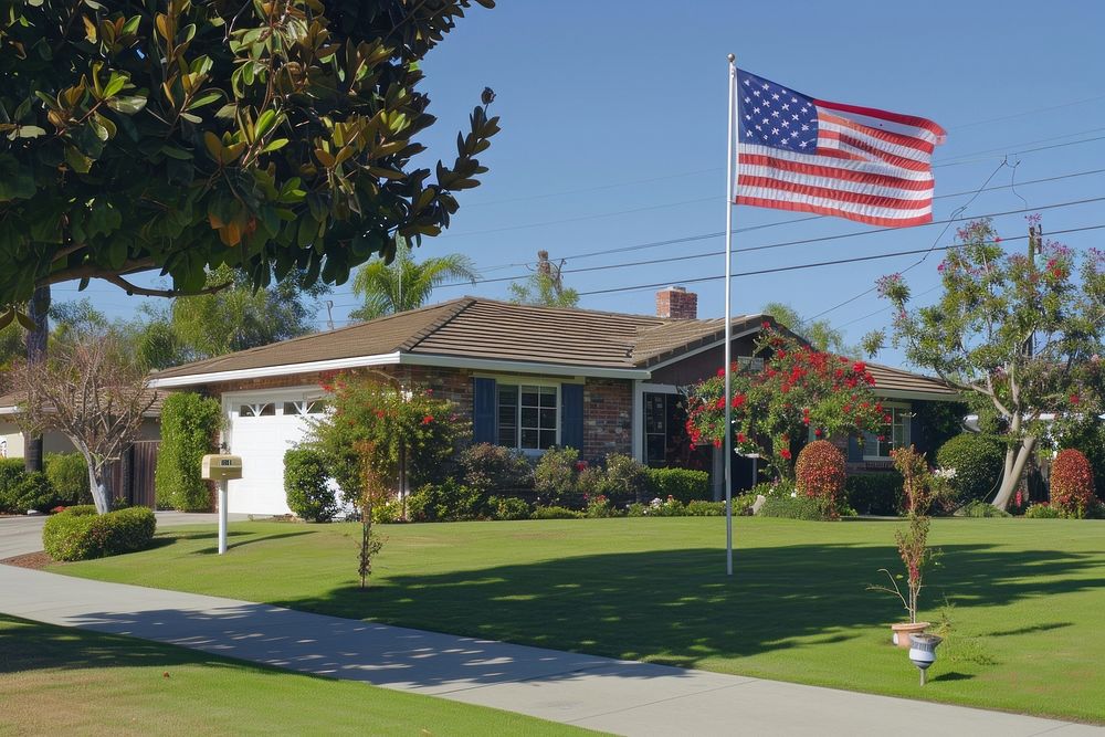 A house with America flag in nice suburb in the north America outdoors plant grass.