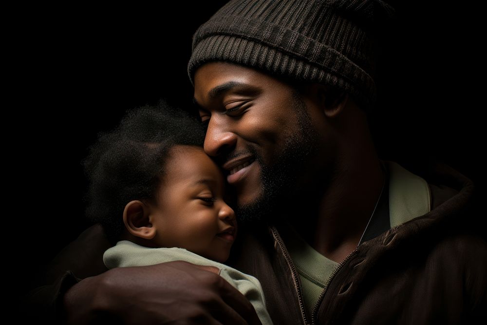 Black father baby portrait smiling.