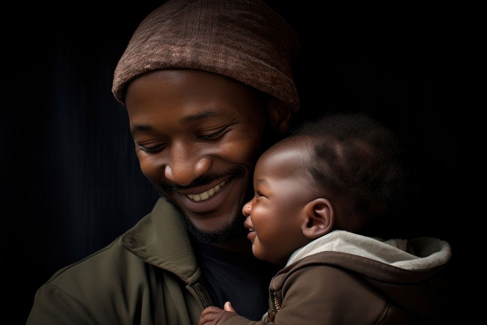Black father baby portrait smiling.