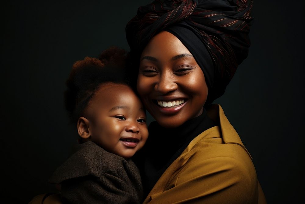 Black mother holding her baby portrait smiling child.