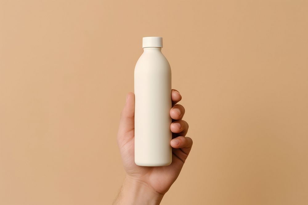 Dropper bottle  holding hand milk.