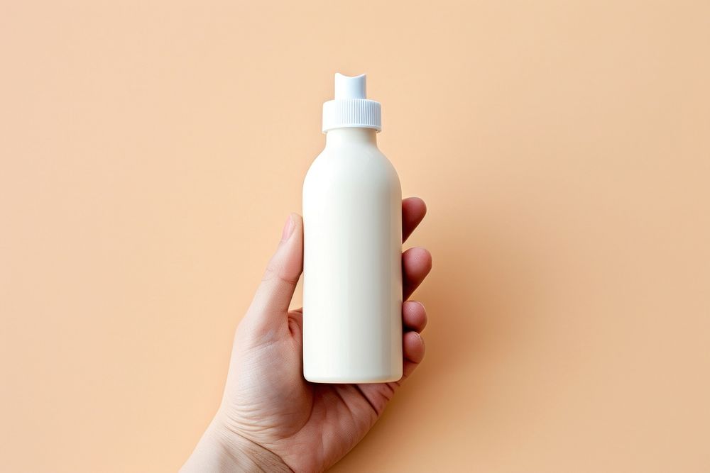 Dropper bottle  holding milk hand.