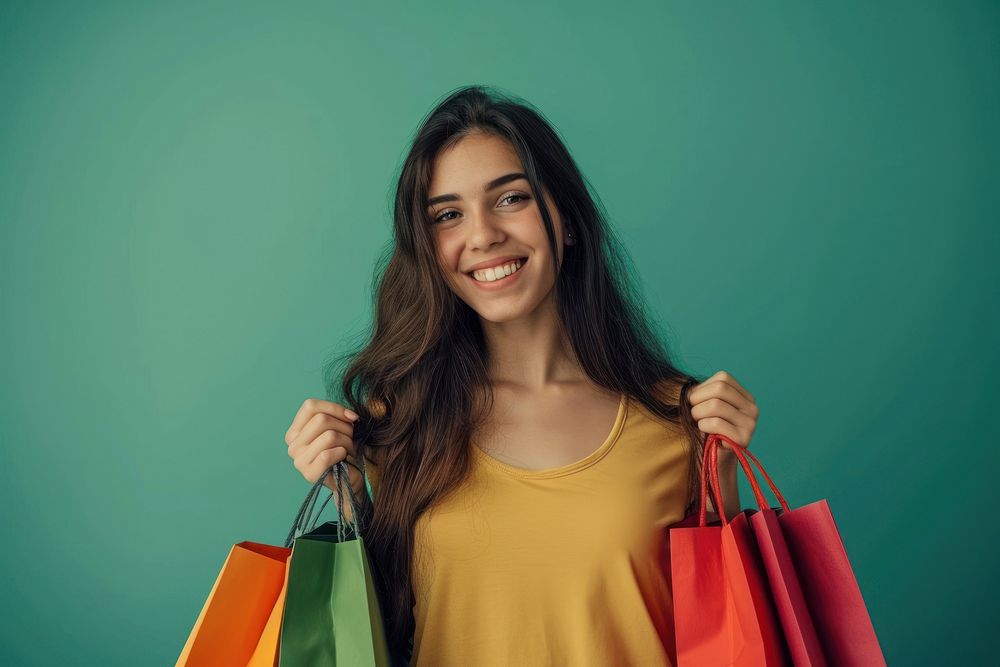 Happy young Latin lady holding shopping bags smile adult consumerism.