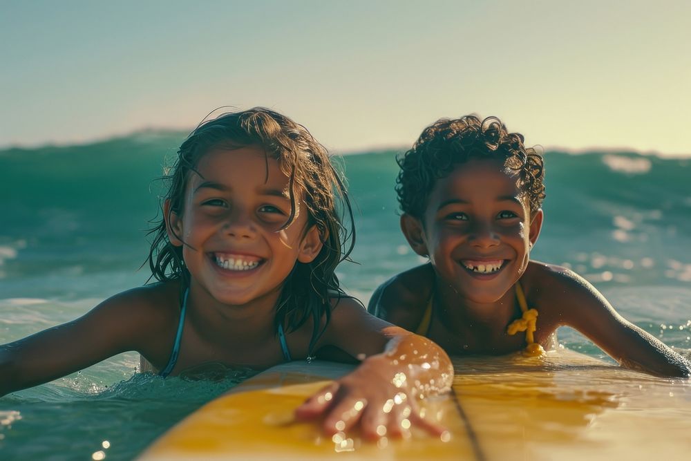 Two diversity cool kids surfing smile swimming laughing.