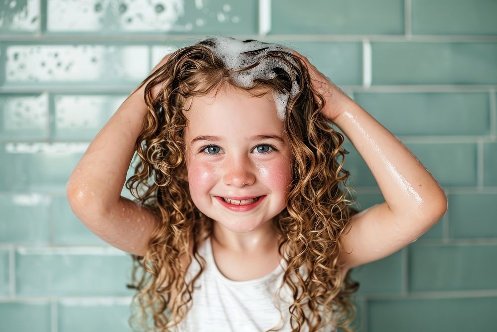 A happy kid washing hair bathroom child smile.