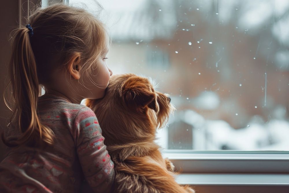 A girls with a dog looking out the window view mammal photo child.
