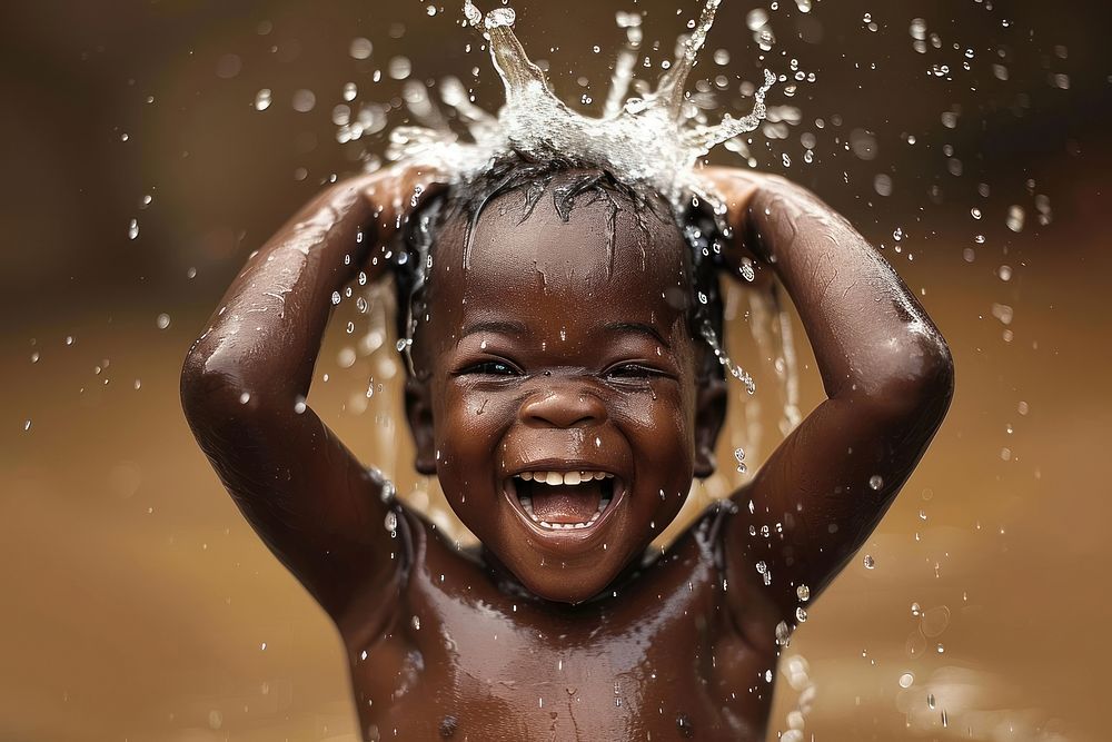 A happy black boy washing hair bathing baby happiness.