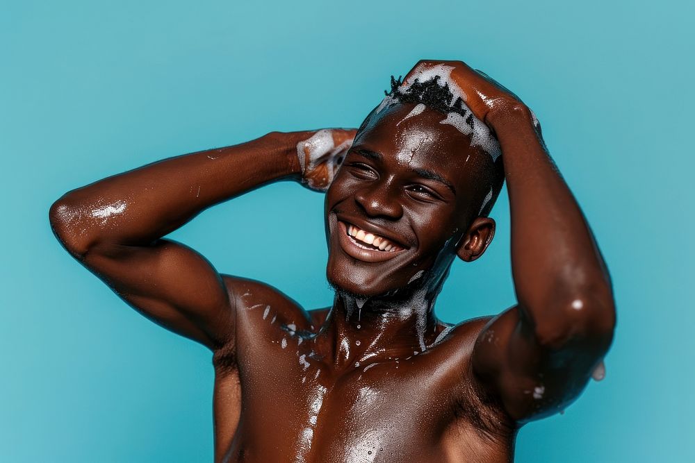 A happy black guy washing hair bathroom bodybuilding happiness.