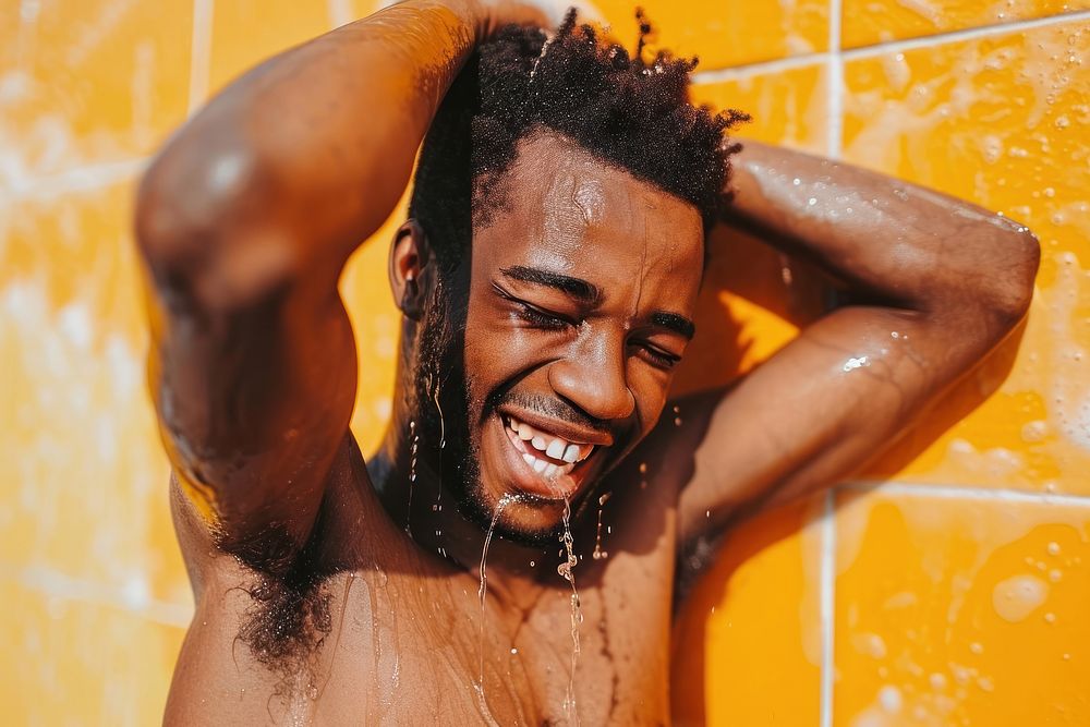 A happy black guy washing hair bathroom bathing shower.