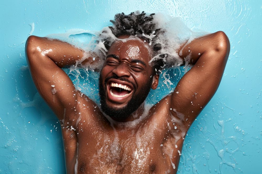A happy black guy washing hair laughing bathroom adult.