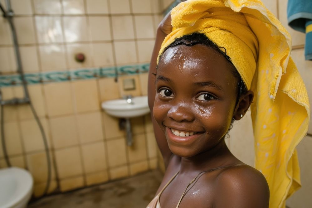 A happy black girl washing hair bathroom bathing accessories.