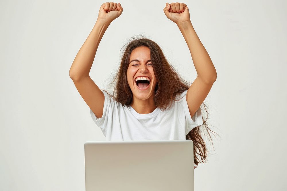 A happy woman sitting with her labtop and celebrating act shouting computer laptop.