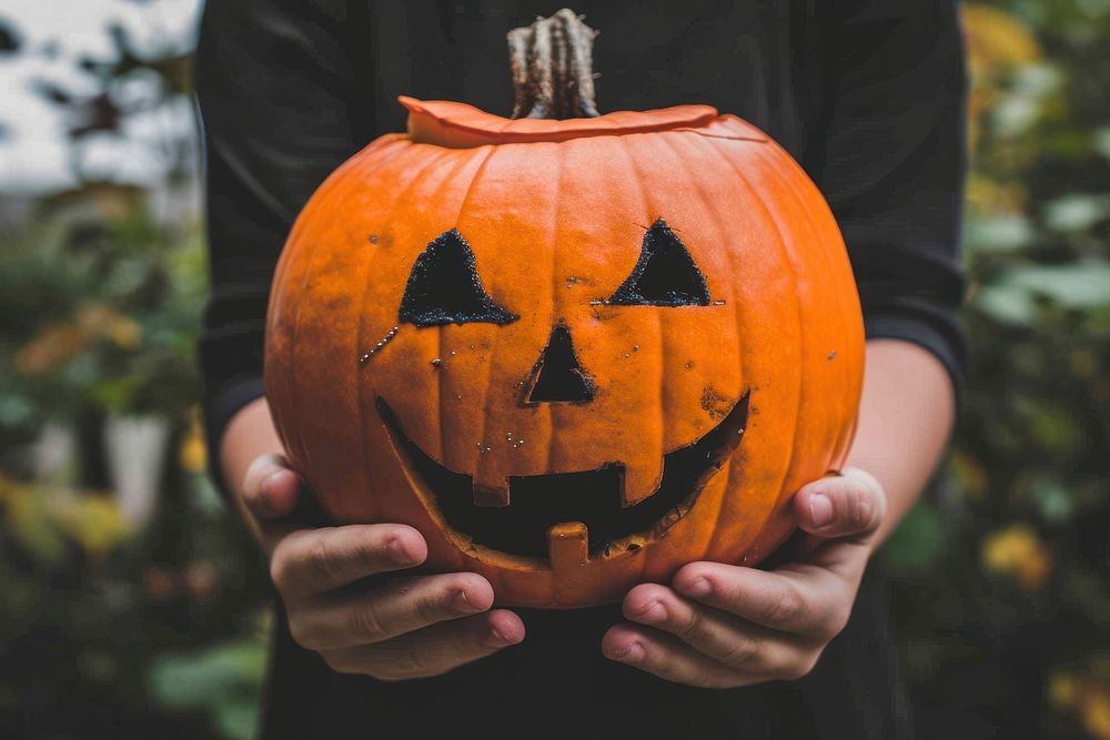 A kid holding halloween pumpkin anthropomorphic jack-o'-lantern jack-o-lantern.