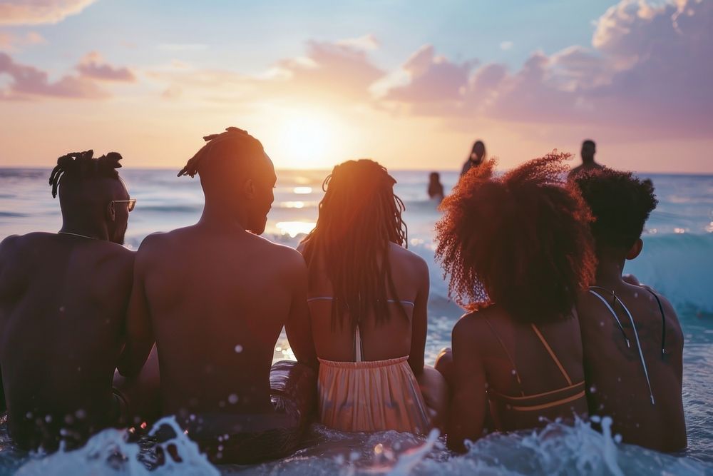 Happy black people group of friends vacation outdoors sunset.