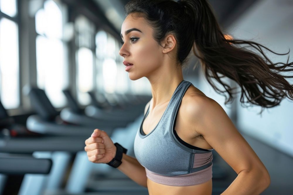 Hispanic woman running adult gym determination.