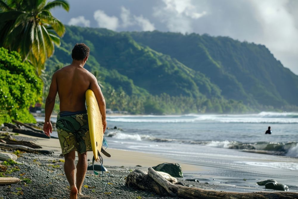 A Samoan man holding surf board outdoors walking surfing.
