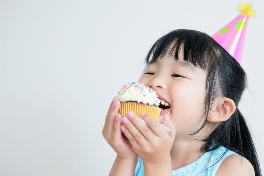 Asia girl eatting cupcake portrait birthday child.