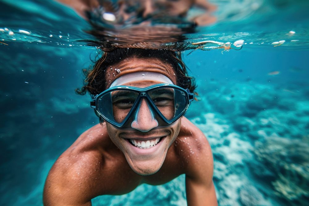 Happy samoan young diver diving underwater recreation swimming.