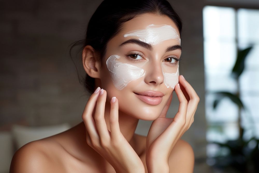 Woman applying skin face cream cosmetics adult cheek.