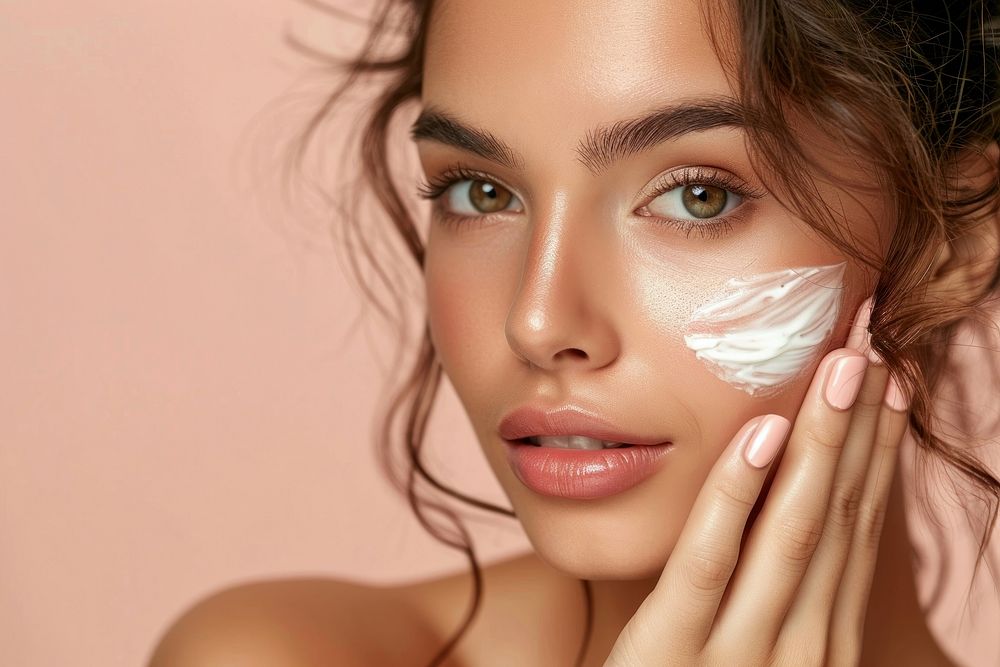 Woman using skin face cream cosmetics adult cheek.
