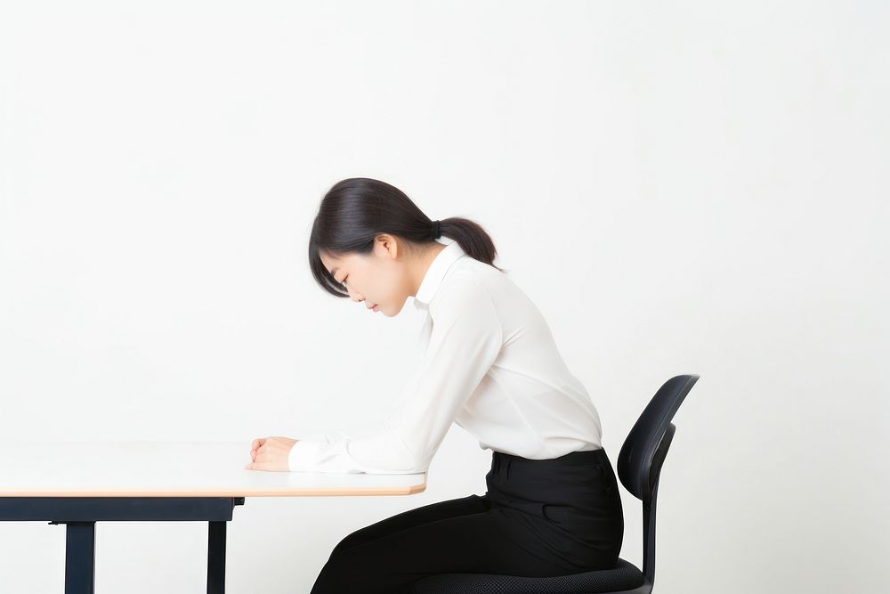 An east asian woman suffering from work sitting furniture working.
