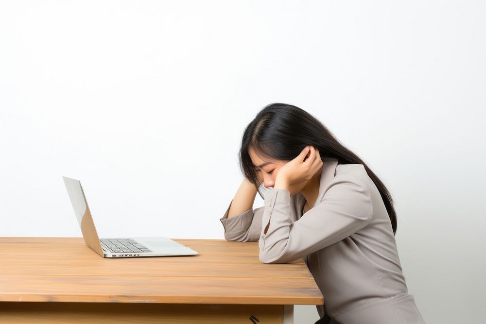 An east asian woman suffering from work computer worried sitting.