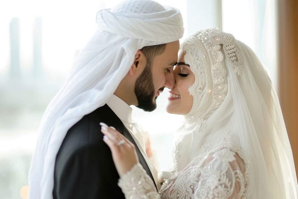Middle eastern couple kissing in their wedding day smiling dress bride.