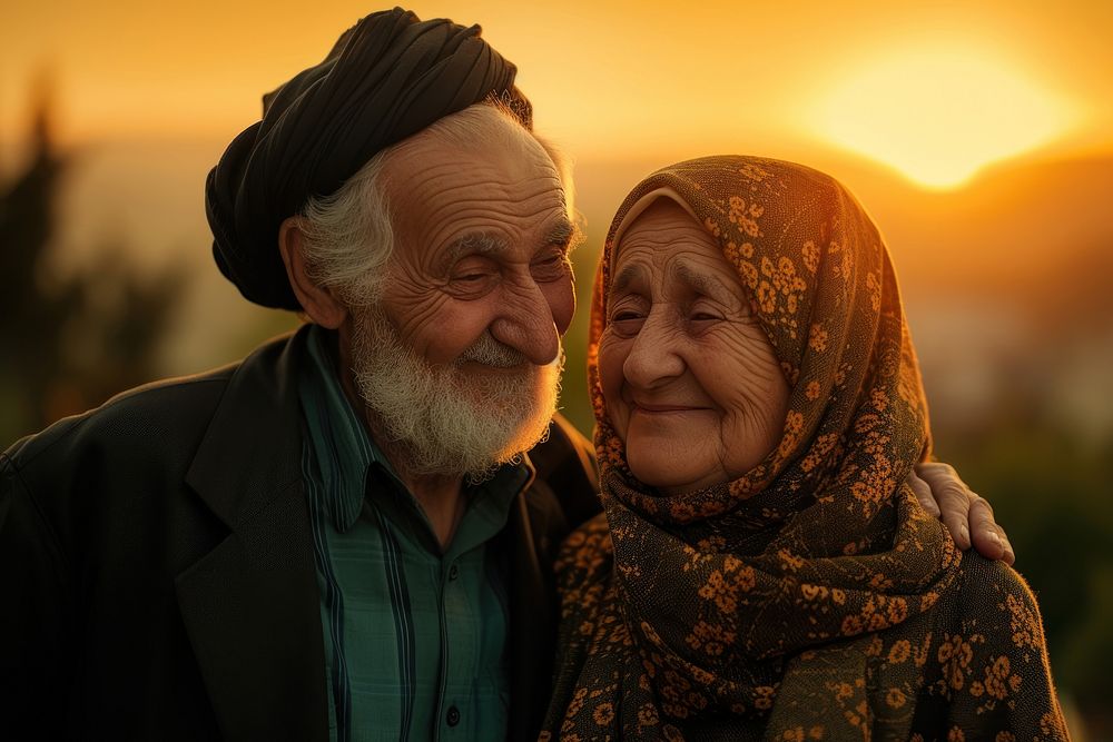 Senior Middle eastern couple taking care each other portrait smiling sunset.