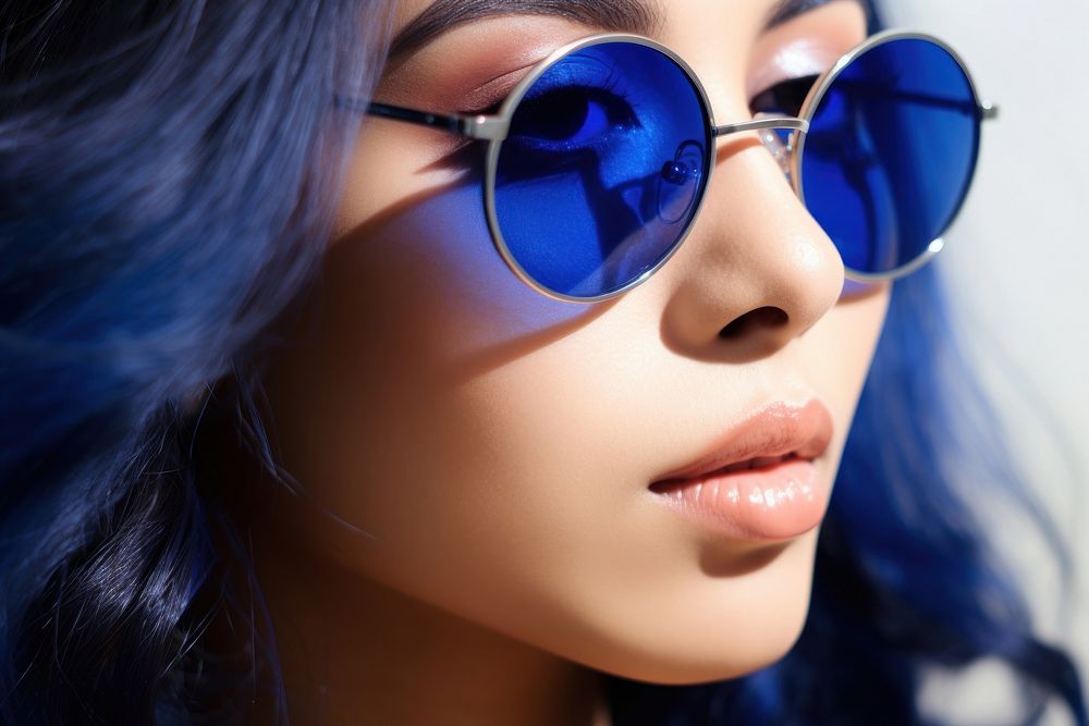 A Indonesian woman south east asian wear fashionable blue sunglasses adult eye accessories.