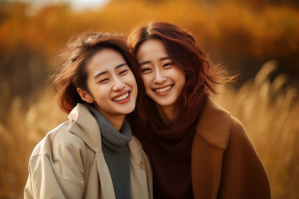 Korean lesbian couple smile laughing outdoors adult.