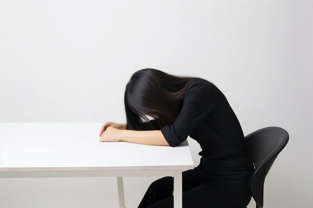 An east asian woman suffering from headache sitting adult photo.