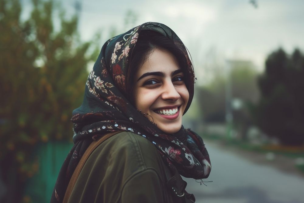 Young smiling middle eastern woman with scarf portrait smile happy.