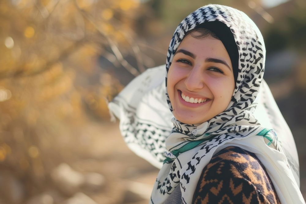 Young smiling middle eastern woman with scarf portrait smile happy.
