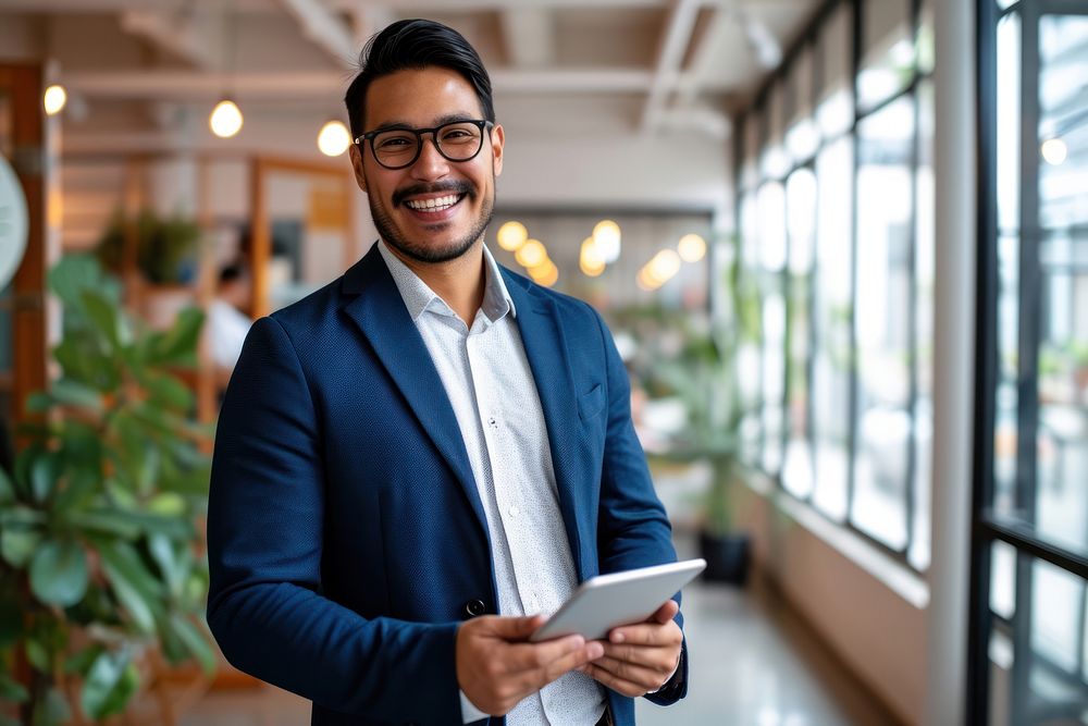 Hispanic business man smiling whild holding a tablet office adult entrepreneur. AI generated Image by rawpixel.