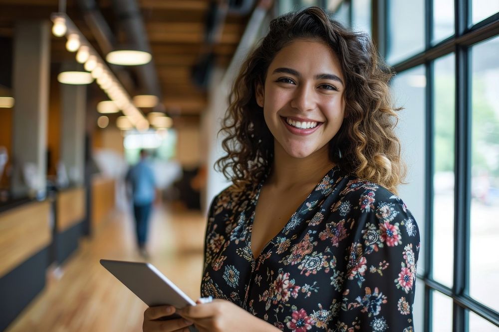 Hispanic woman smiling whild holding a tablet smile adult entrepreneur. AI generated Image by rawpixel.