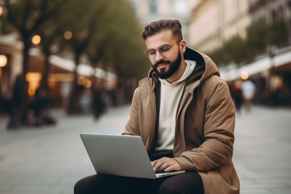 Man holding laptop computer sitting adult.