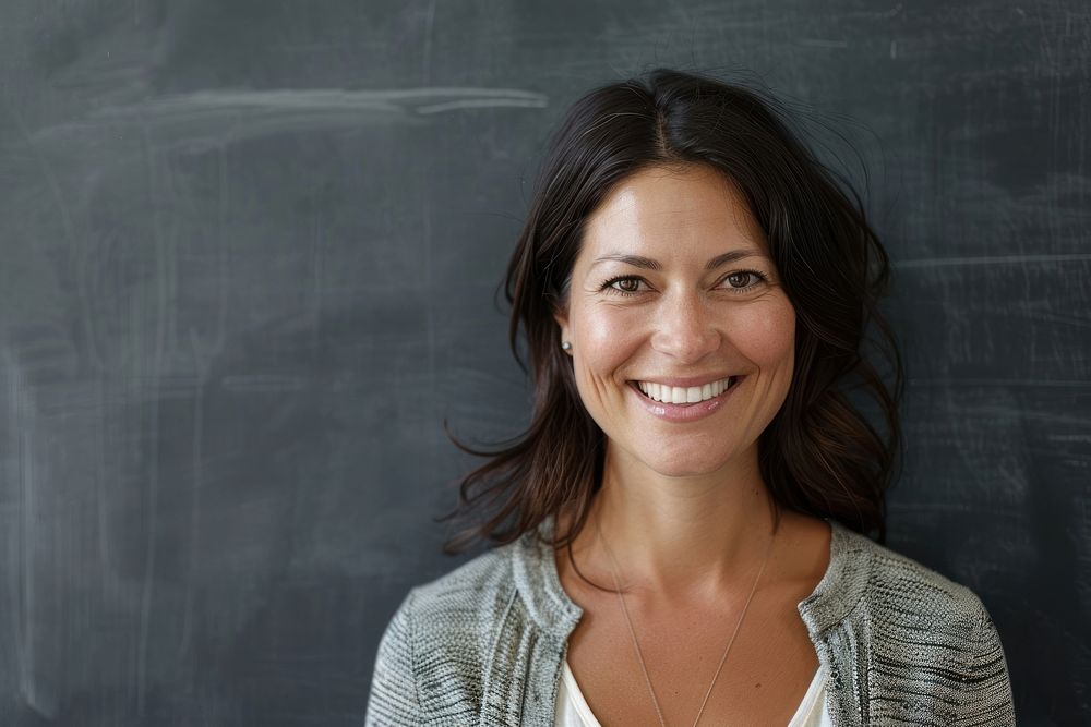 Woman teacher blackboard portrait smiling.