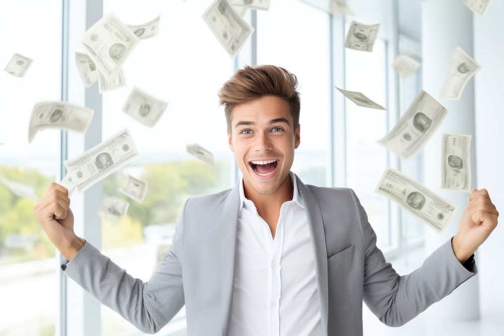 Young man holding money banknotes cheerful portrait achievement.