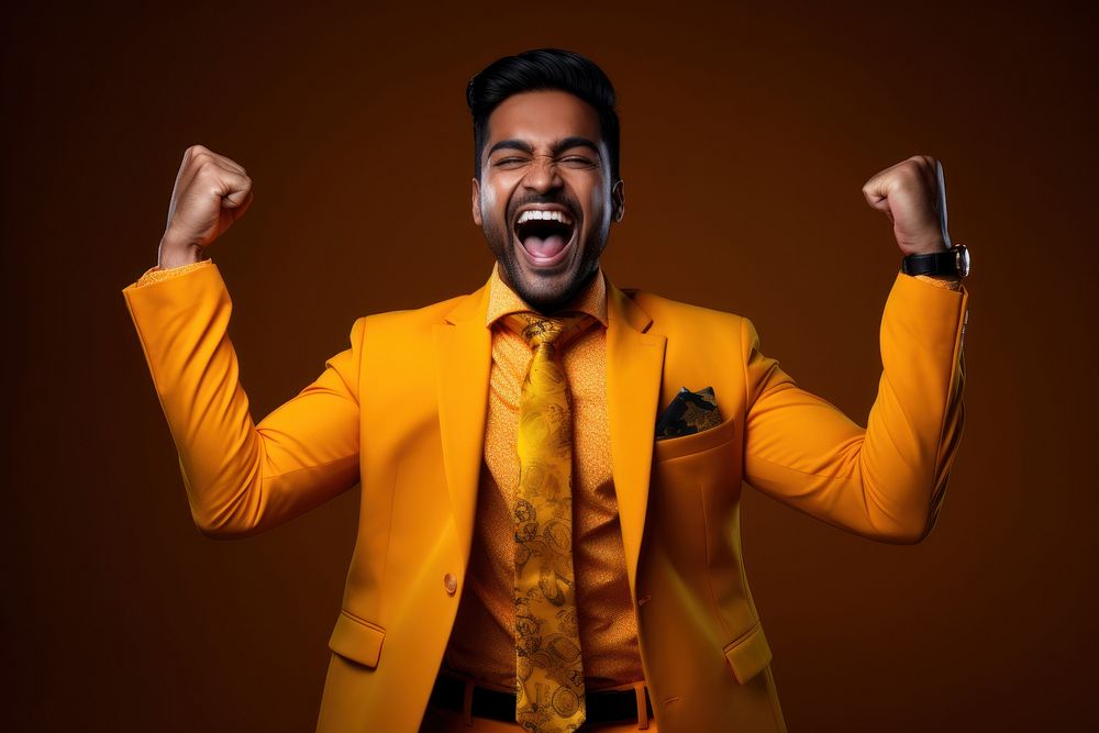 Happy young indian man shouting laughing success.