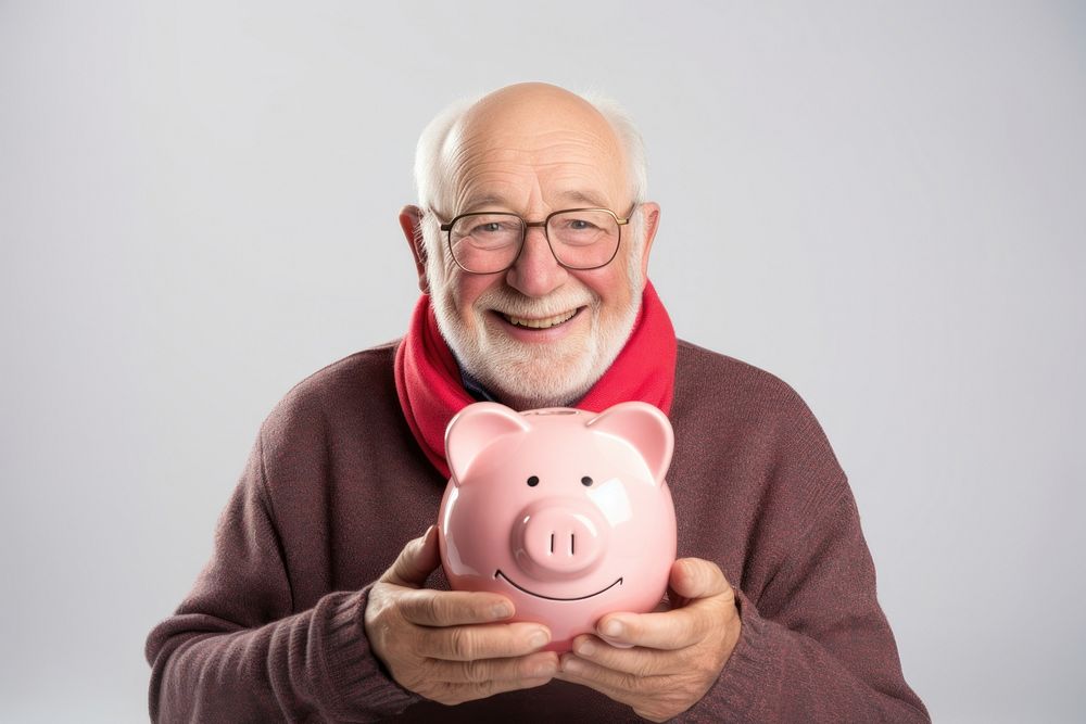 Man holding his piggy bank happy retirement investment.