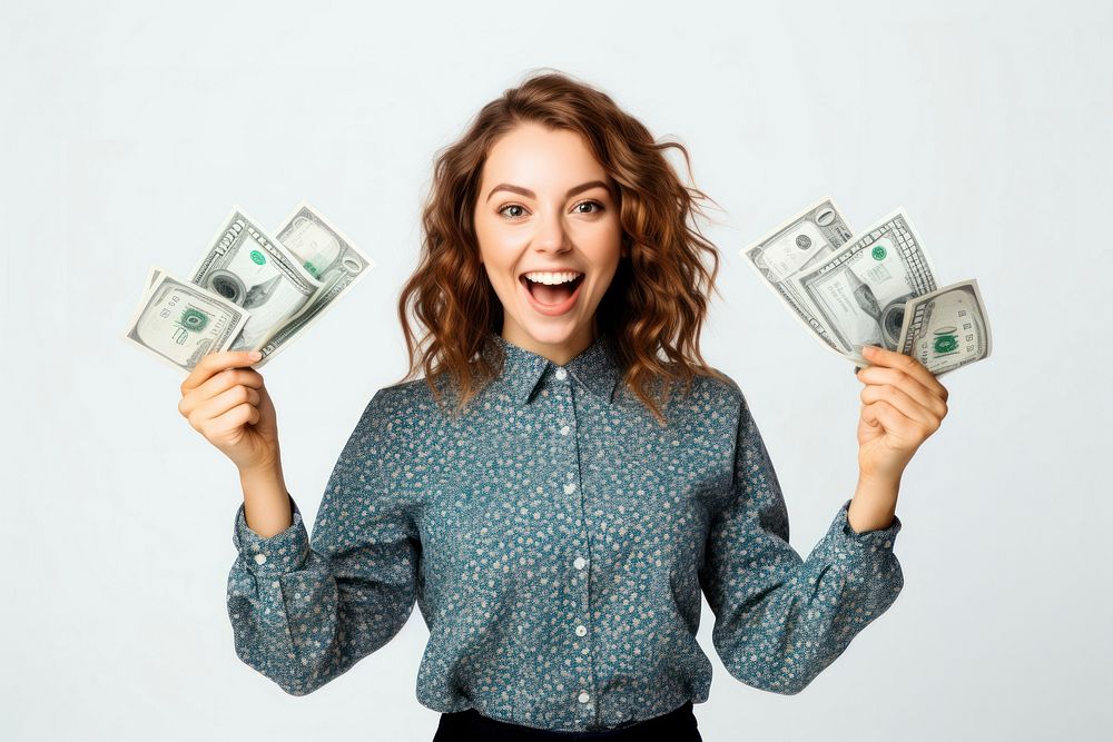 Portrait of a cheerful young woman holding money banknote portrait blouse.