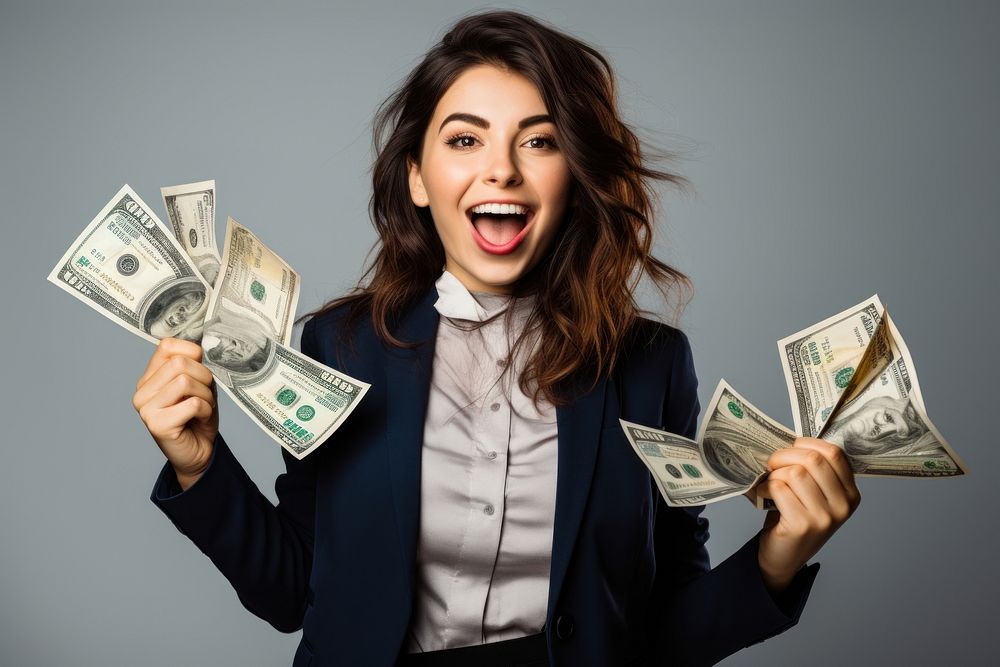 Portrait of a cheerful young woman holding money banknote portrait dollar.